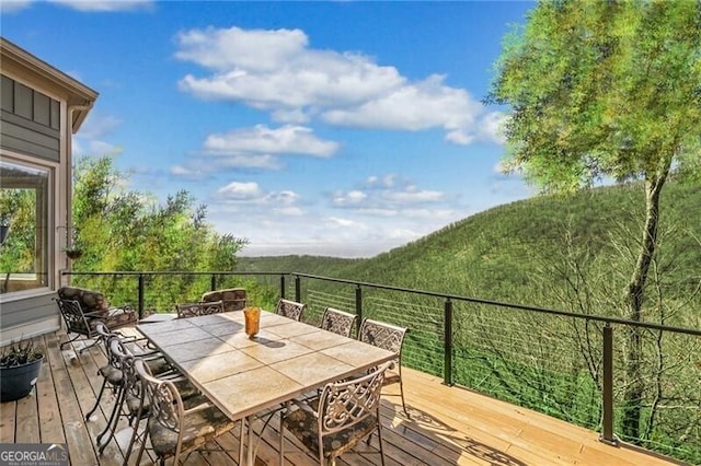 deck with outdoor dining area