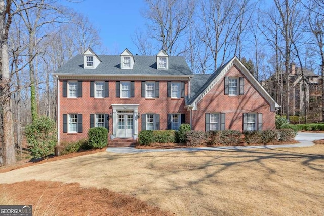 view of front of property with a front yard and brick siding