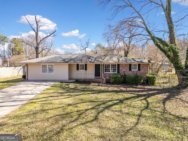 ranch-style home with driveway, brick siding, a front yard, and fence