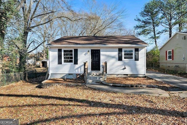 bungalow-style home featuring crawl space, fence, and entry steps