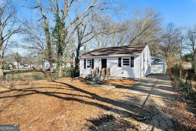 view of front of home with an outbuilding, a garage, fence, driveway, and crawl space