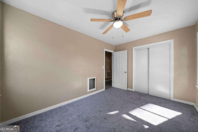 unfurnished bedroom with ceiling fan, carpet floors, visible vents, baseboards, and a closet