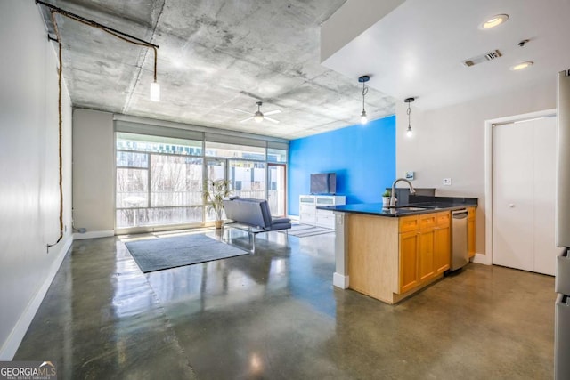 kitchen featuring finished concrete flooring, baseboards, visible vents, a peninsula, and a sink