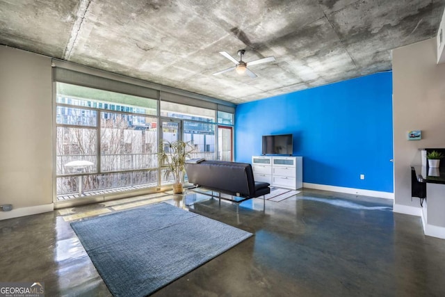 interior space with finished concrete flooring, plenty of natural light, and baseboards