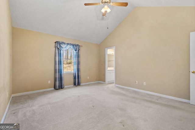 spare room featuring high vaulted ceiling, carpet flooring, baseboards, and a ceiling fan