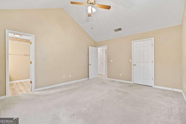 unfurnished bedroom featuring high vaulted ceiling, carpet flooring, visible vents, and baseboards