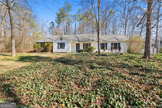 ranch-style home with a front lawn