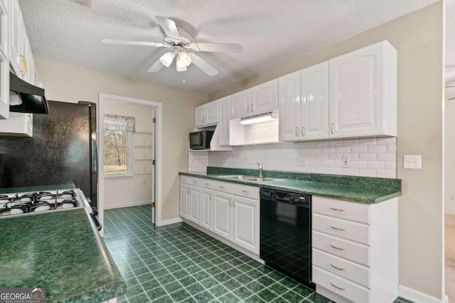 kitchen with dark countertops, black appliances, white cabinetry, and a sink