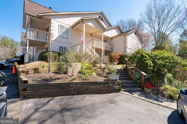 view of front of property with stairway and stucco siding