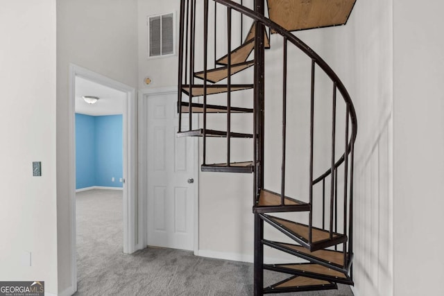 staircase featuring carpet, visible vents, and baseboards