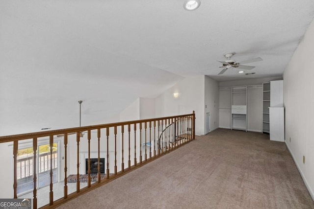 interior space with vaulted ceiling, carpet flooring, and baseboards