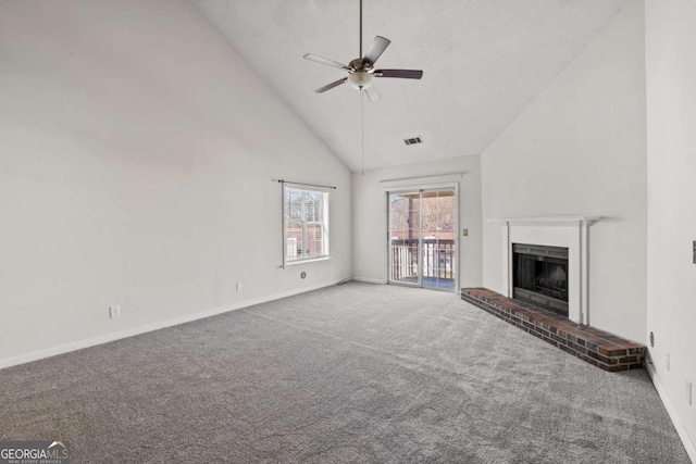 unfurnished living room featuring carpet floors, a fireplace, visible vents, ceiling fan, and high vaulted ceiling