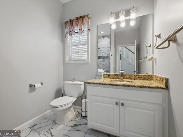 full bathroom with toilet, vanity, baseboards, marble finish floor, and a shower