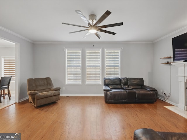 living room with light wood-style floors, a fireplace with flush hearth, plenty of natural light, and ornamental molding