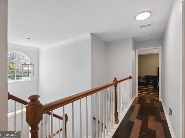 hall featuring visible vents, dark wood finished floors, an upstairs landing, and baseboards