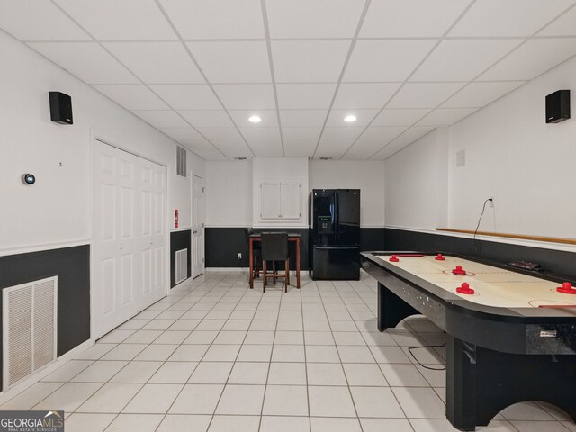 recreation room with light tile patterned floors, a drop ceiling, visible vents, and recessed lighting