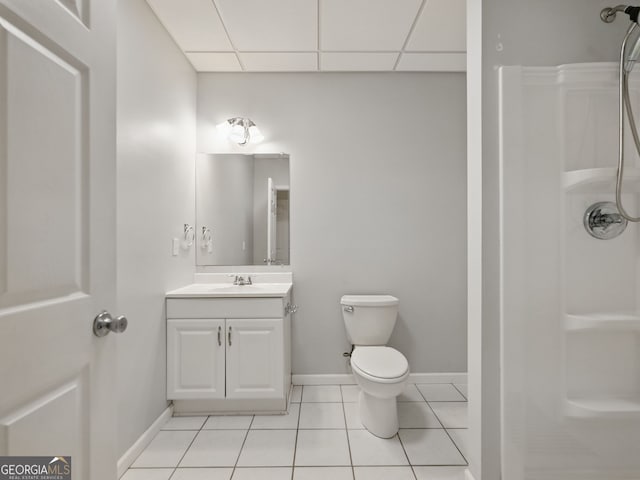 full bathroom with a shower, toilet, vanity, tile patterned flooring, and a drop ceiling