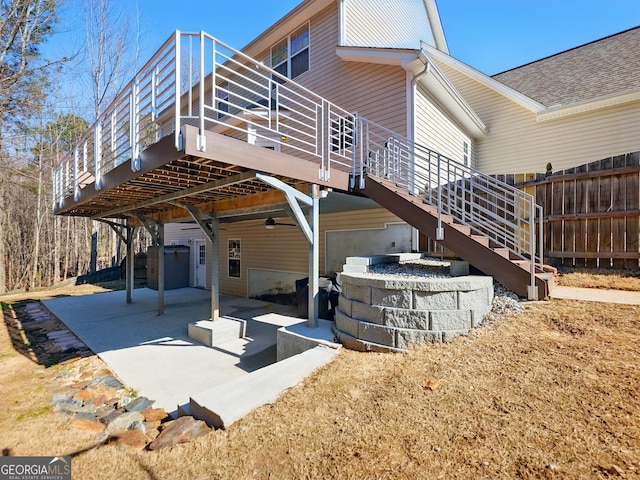 rear view of house featuring stairs, a patio, and fence