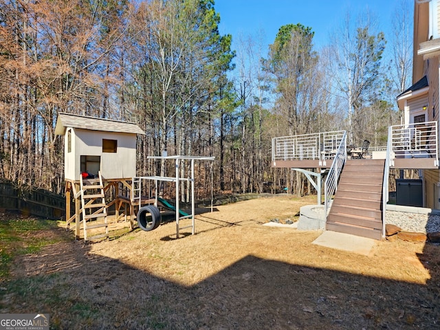 view of yard with stairs and a playground