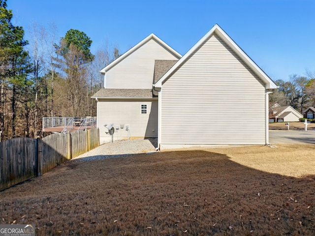 view of side of property with a yard and fence