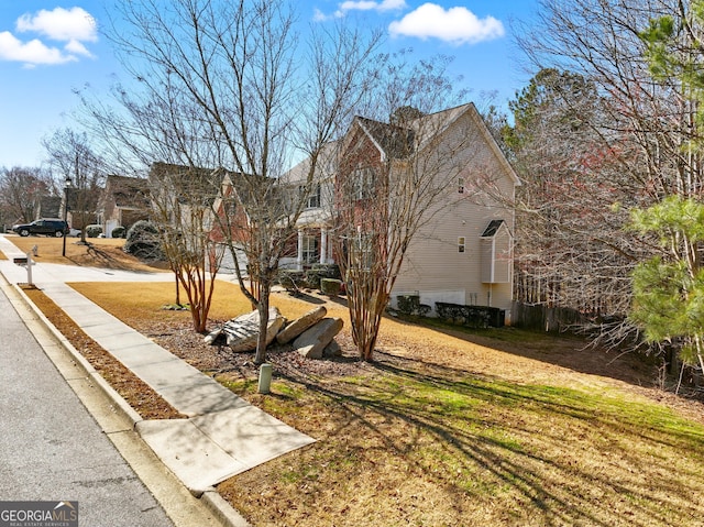 view of property exterior featuring a lawn