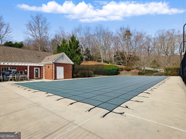 view of swimming pool with a patio area and a covered pool