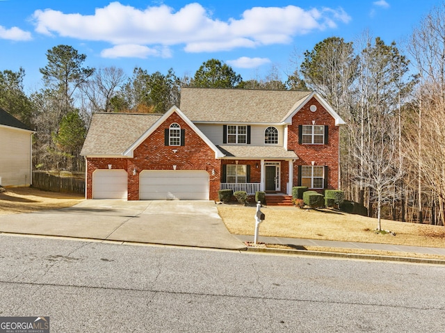 view of front facade with a porch, brick siding, driveway, and roof with shingles