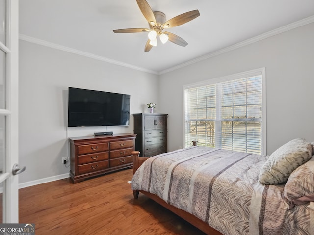 bedroom featuring crown molding, baseboards, and wood finished floors