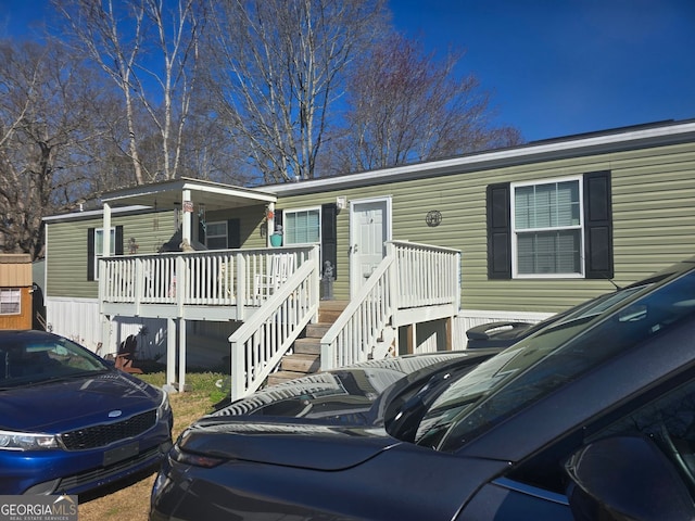 view of front of property featuring a wooden deck