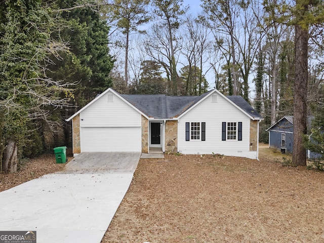 ranch-style home featuring crawl space, stone siding, a garage, and concrete driveway