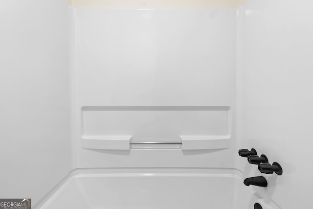 room details featuring tub / shower combination