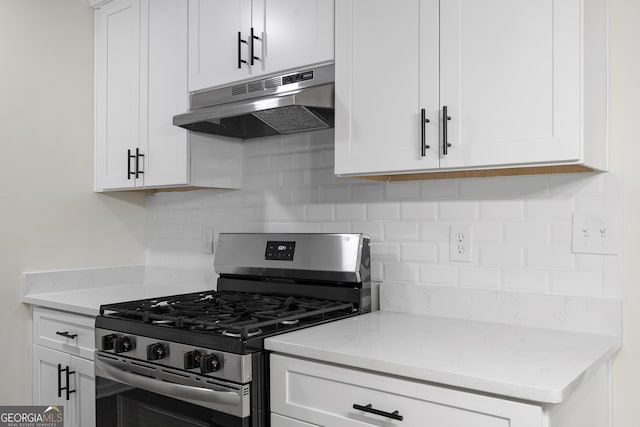 kitchen featuring tasteful backsplash, stainless steel range with gas cooktop, white cabinetry, and under cabinet range hood