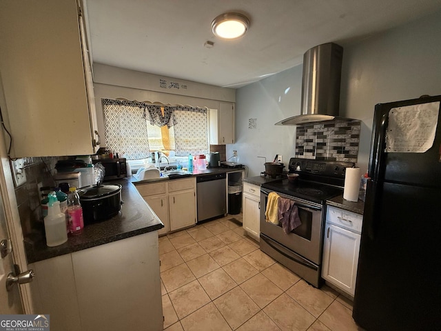 kitchen featuring dark countertops, wall chimney range hood, stainless steel appliances, and decorative backsplash