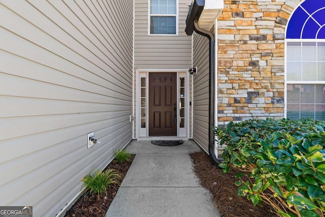 entrance to property with stone siding