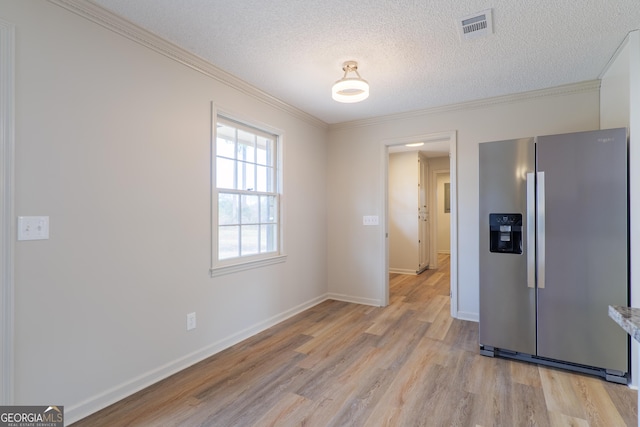 kitchen with ornamental molding, light wood-style floors, visible vents, and stainless steel fridge with ice dispenser