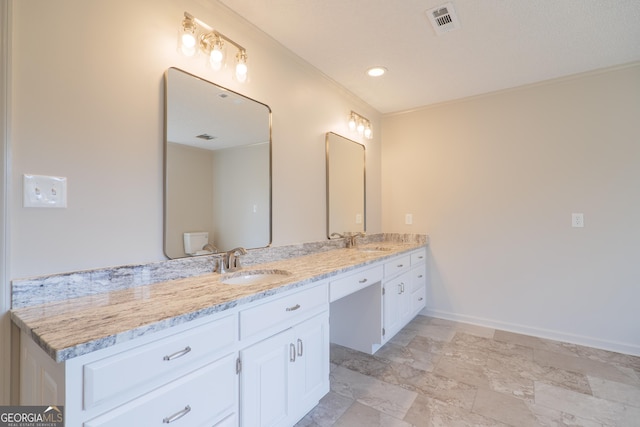 full bath featuring double vanity, baseboards, visible vents, and a sink