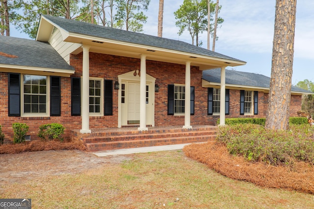 ranch-style house with crawl space, brick siding, and roof with shingles