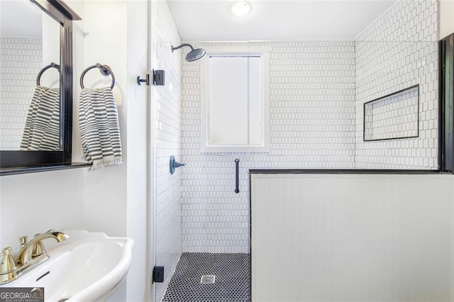 bathroom featuring a stall shower and a sink