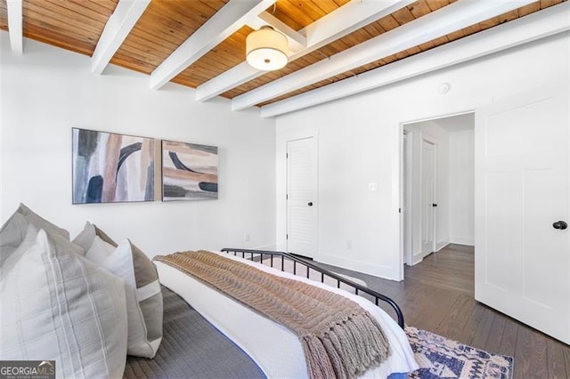 bedroom with beamed ceiling, wooden ceiling, hardwood / wood-style flooring, and baseboards