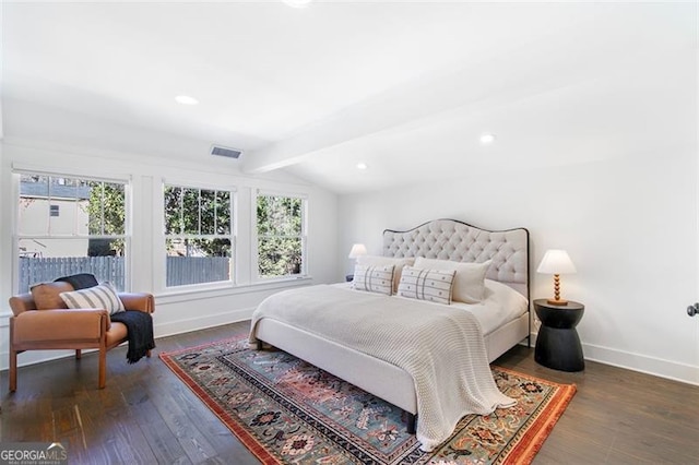 bedroom featuring visible vents, vaulted ceiling with beams, baseboards, and wood finished floors