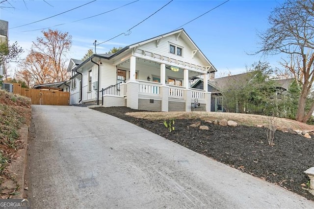 view of front of home with fence and a porch