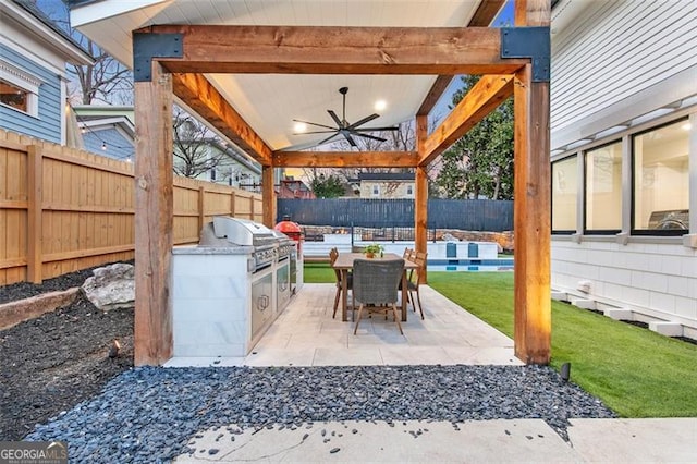 view of patio featuring a ceiling fan, outdoor dining area, a fenced backyard, and area for grilling