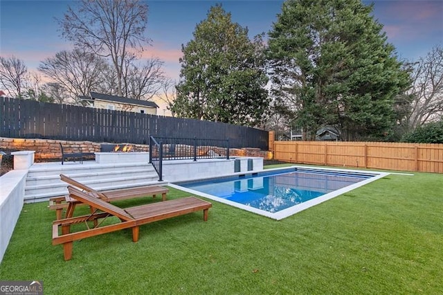 view of swimming pool featuring a fenced in pool, a fenced backyard, and a lawn