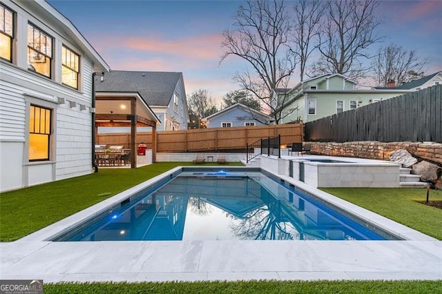 view of swimming pool featuring a fenced in pool, a patio area, a fenced backyard, and a lawn