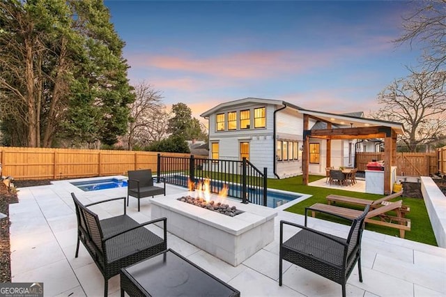 view of patio featuring an outdoor fire pit, a fenced backyard, and a fenced in pool