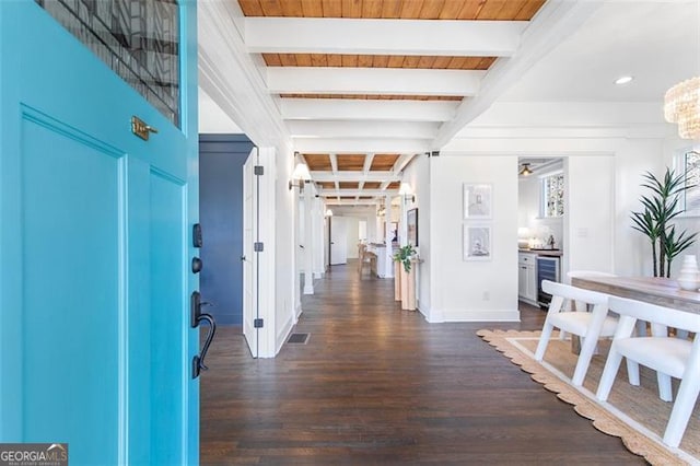 entryway featuring wine cooler, visible vents, baseboards, beam ceiling, and dark wood-style floors