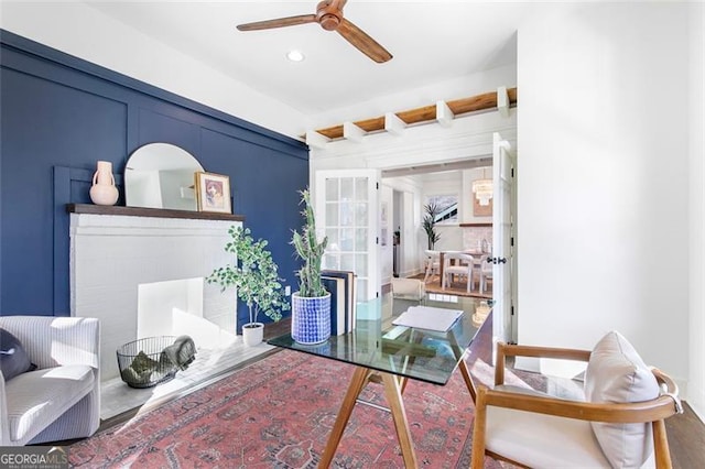 home office with ceiling fan, recessed lighting, and a decorative wall