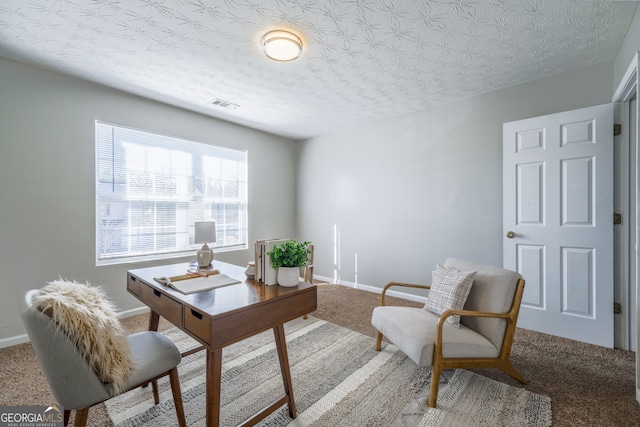 home office featuring carpet, a textured ceiling, visible vents, and baseboards