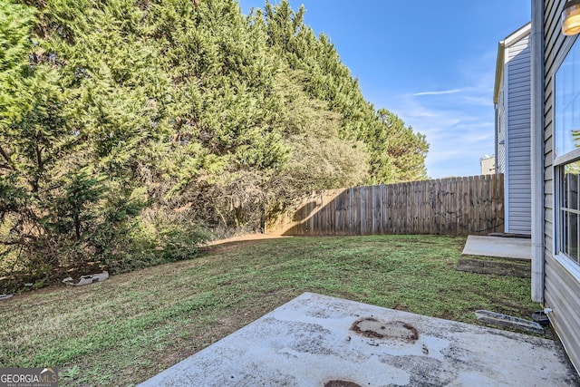 view of yard featuring fence and a patio