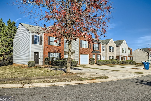 multi unit property featuring a residential view, brick siding, driveway, and an attached garage